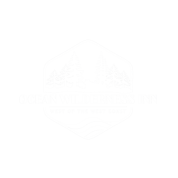 Ocean Wilderness Inn logo in white with lettering across the front, trees and small wave patterns.