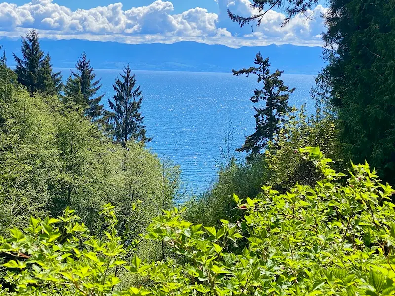 Scenic view from the front lawn at Ocean Wilderness Inn looking across the Juan de Fuca Strait toward the Olympic Mountains.