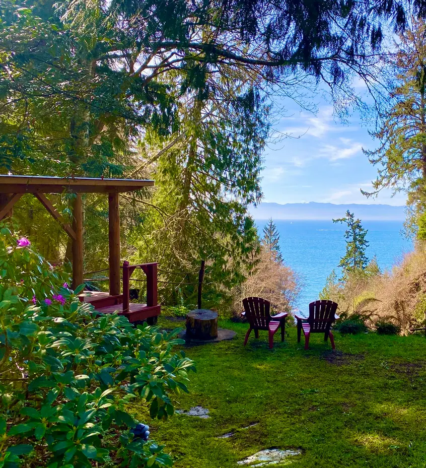 Lawn and wooden gazebo overlooking the Juan de Fuca Strait and Olympic Mountains at Ocean Wilderness Inn in Shirley, BC